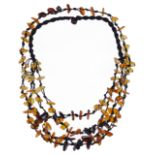 A modern polished amber and silk multi strand necklace