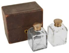 Two cased glass scent/cologne bottles