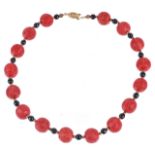 A reproduction Chinese red lacquer bead necklace,