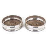 A pair of contemporary silver wine coasters, hallmarked London 1967,