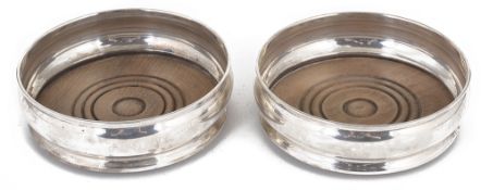 A pair of contemporary silver wine coasters, hallmarked London 1967,