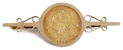 A George V fine gold half sovereign in gold brooch mount,