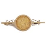 A George V fine gold half sovereign in gold brooch mount,