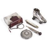 A collection of novelty silver, roller skate pin cushion, fruit knife, prayer book holder, compact,