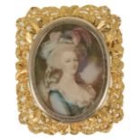 An unusual gold framed, gem set portrait pendant brooch