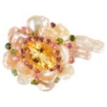 An unusual Continental gold mounted baroque pearl and coloured gem floral brooch