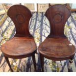 A pair of Victorian mahogany hall chairs