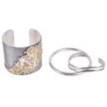 An attractive contemporary silver cuff bracelet and two silver bracelets