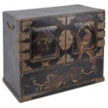 A Meji period Japanese lacquer kodansu (cabinet)with doors to the front decorated with birds and