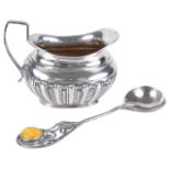 A Polish Baltic amber silver spoon and a Victorian silver cream jugthe spoon with trailing leaves