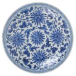 A large Chinese 19th century blue and white charger well painted with scrolling anemones and