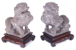 A pair of Chinese carved stone figures of temple guardians, possibly early 19th Century and having