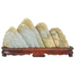 A Chinese late 19th century carved jade scholars mountainmounted on fitted carved hardwood stand
