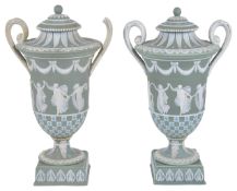 A pair of Wedgwood tri-colour jasperware lidded urns, late 19th/early 20th century