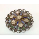 An attractive Eastern silver gilt and enamel circular filigree broochthe brooch enamelled with
