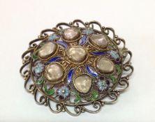 An attractive Eastern silver gilt and enamel circular filigree broochthe brooch enamelled with