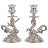 A pair of Continental silver cast candlesticks in the form of a pair of centurion sea gods (