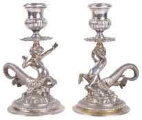 A pair of Continental silver cast candlesticks in the form of a pair of centurion sea gods (