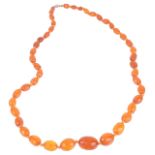 An attractive graduated facetted amber bead necklacethe amber beads of varied honey tones, the beads