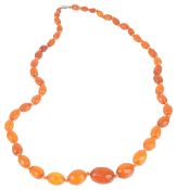 An attractive graduated facetted amber bead necklacethe amber beads of varied honey tones, the beads