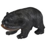 A German Black Forrest bear with fish the bear realistically carved in walking pose with fish
