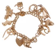 A 9ct gold double curb link charm bracelethung with a variety of charms including a swan, a