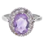An oval amethyst and diamond set cluster ringthe oval light coloured amethyst set within a small