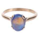 A single stone precious black opal set ringthe oval opal mounted in a yellow metal mount, tests