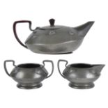 An Arts and Crafts Warric pewter three piece tea servicethe teapot, twin handled sugar basin and