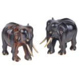 A pair of Indian hardwood elephants, 20th centuryeach standing with bone tusks and eyes, a/f, (2)