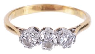 A three stone diamond set ringthe centre stone approximately 0.21ct and flanked by a slightly