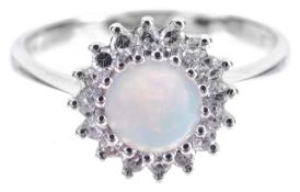 A delicate opal and diamond set daisy cluster ringthe central circular opal with good colour display