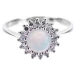 A delicate opal and diamond set daisy cluster ringthe central circular opal with good colour display
