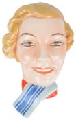 A Czechoslovakian Art Deco pottery wall mask of a girl, wearing a blue stripped scarf, bears marks