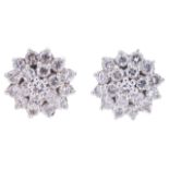 A pair of contemporary diamond set cluster earringshaving central diamond surrounded by two rows
