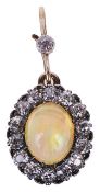 An attractive Edwardian "jelly" opal and diamond cluster pendant,the oval opal, approximate weight