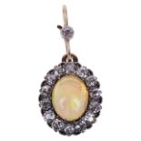 An attractive Edwardian "jelly" opal and diamond cluster pendant,the oval opal, approximate weight