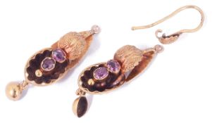 A pair of small Victorian almandine garnet shell scroll earringsthe yellow metal drops of scroll