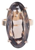 A large gold mounted smokey quartz set dress ringthe facetted oval stone in 9ct gold mount, circa