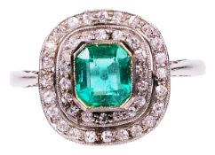 An attractive Art Deco emerald and diamond set cluster ringthe central octagonal emerald, set within