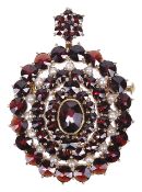 A Victorian style garnet and seed pearl oval cluster pendant broochthe hanging loop hinged and set