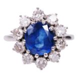 An attractive contemporary sapphire and diamond set cluster ringthe oval sapphire set within a