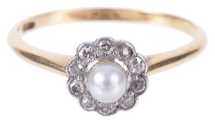 A delicate Edwardian pearl and diamond 'daisy' cluster ring,having central set pearl within a