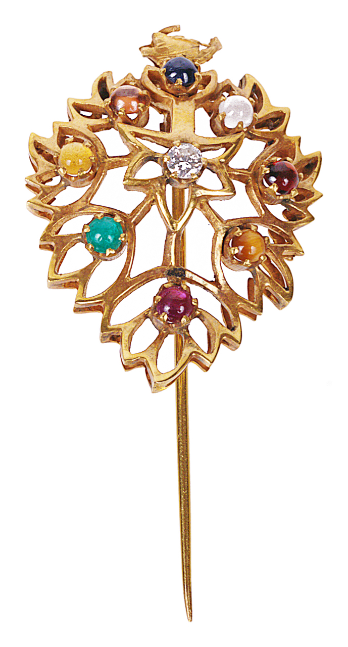 An eastern diamond and gem set hinged turban pin the pierced and shaped stylised foliate pin set