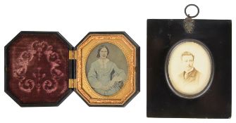 A pressed vulcanite daguerreotype case of octagonal form the hinged frame with relief scroll