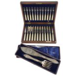 A mahogany cased suite of twelve ivorine handled fruit knives and forks, with retail label for
