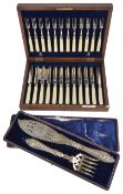 A mahogany cased suite of twelve ivorine handled fruit knives and forks, with retail label for