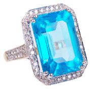 A large and striking modern Swiss blue topaz and diamond set fancy ringthe large emerald cut topaz