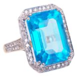 A large and striking modern Swiss blue topaz and diamond set fancy ringthe large emerald cut topaz