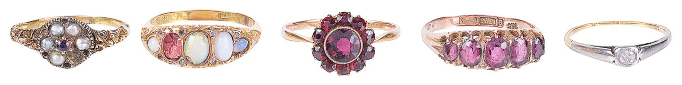 An Edwardian garnet set five stone ring and four other ringsthe five stone garnet ring having 9ct